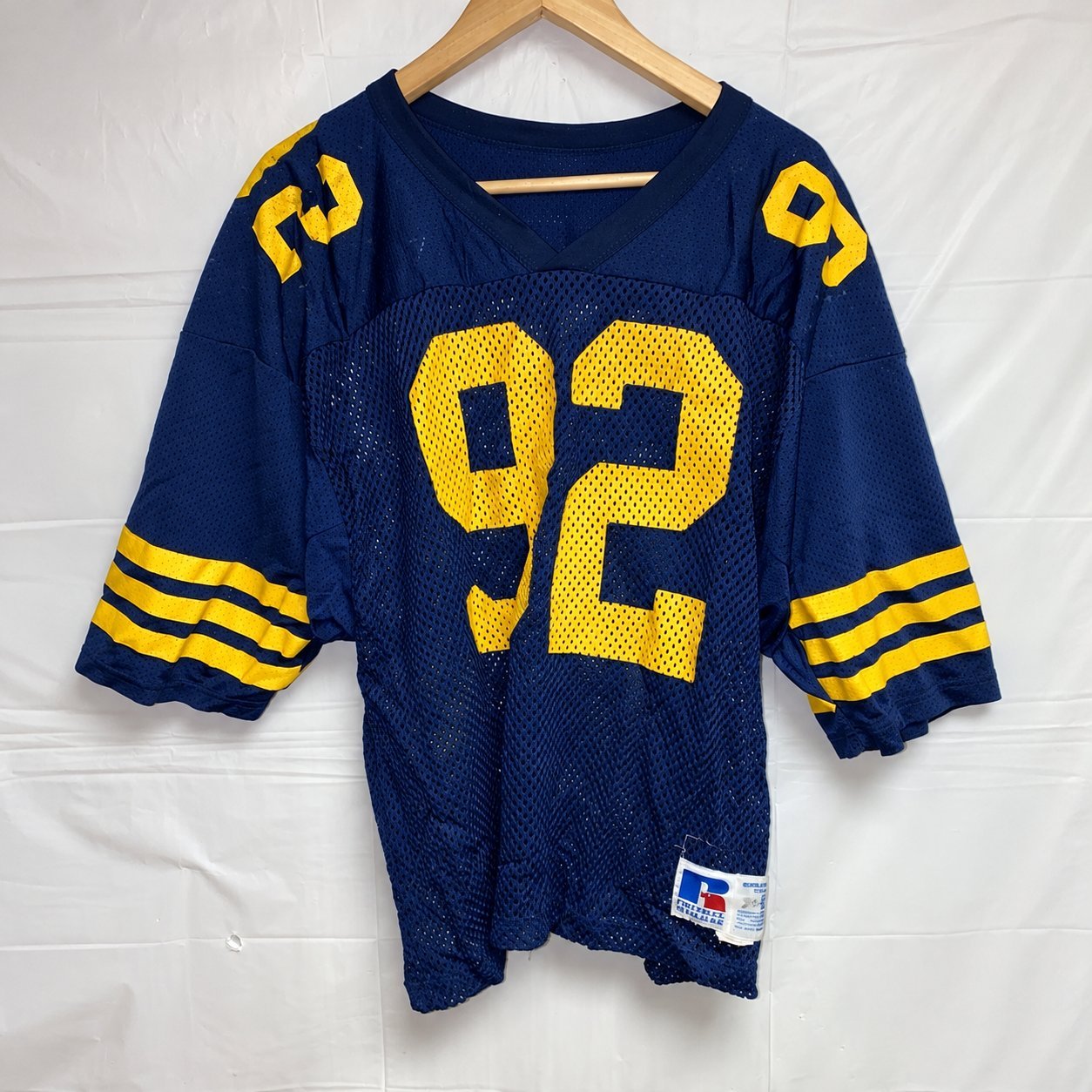 Navy mesh throwback football jersey with gold sleeve stripes and number 92