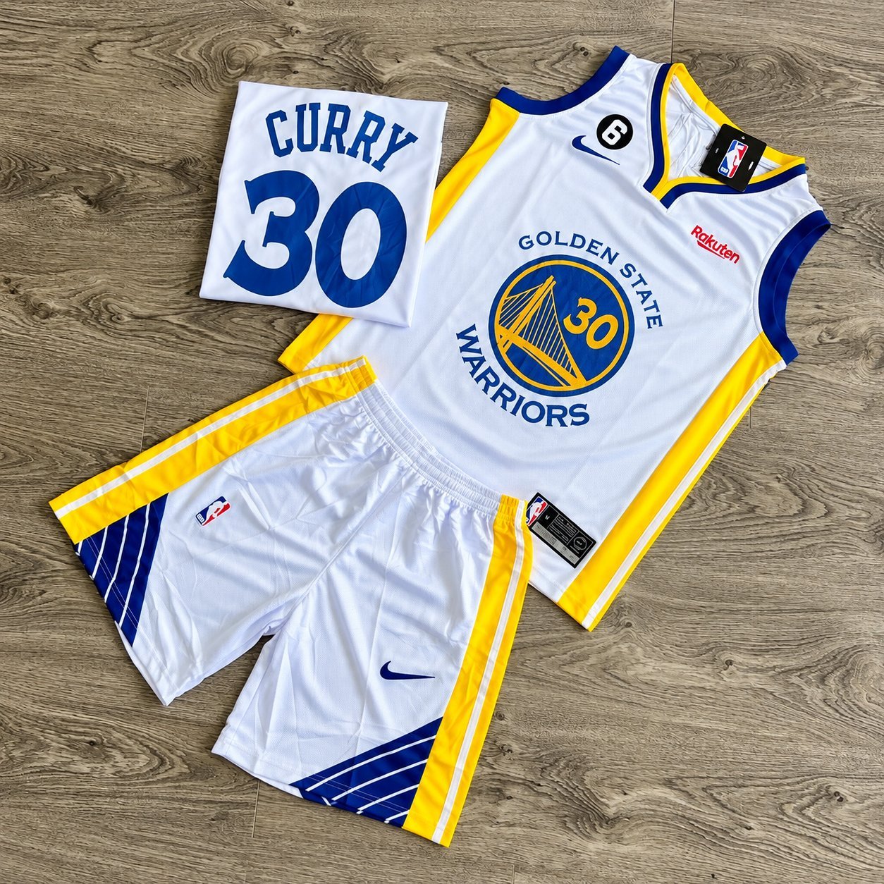 White Golden State Warriors Stephen Curry #30 away jersey set with yellow trim and matching shorts